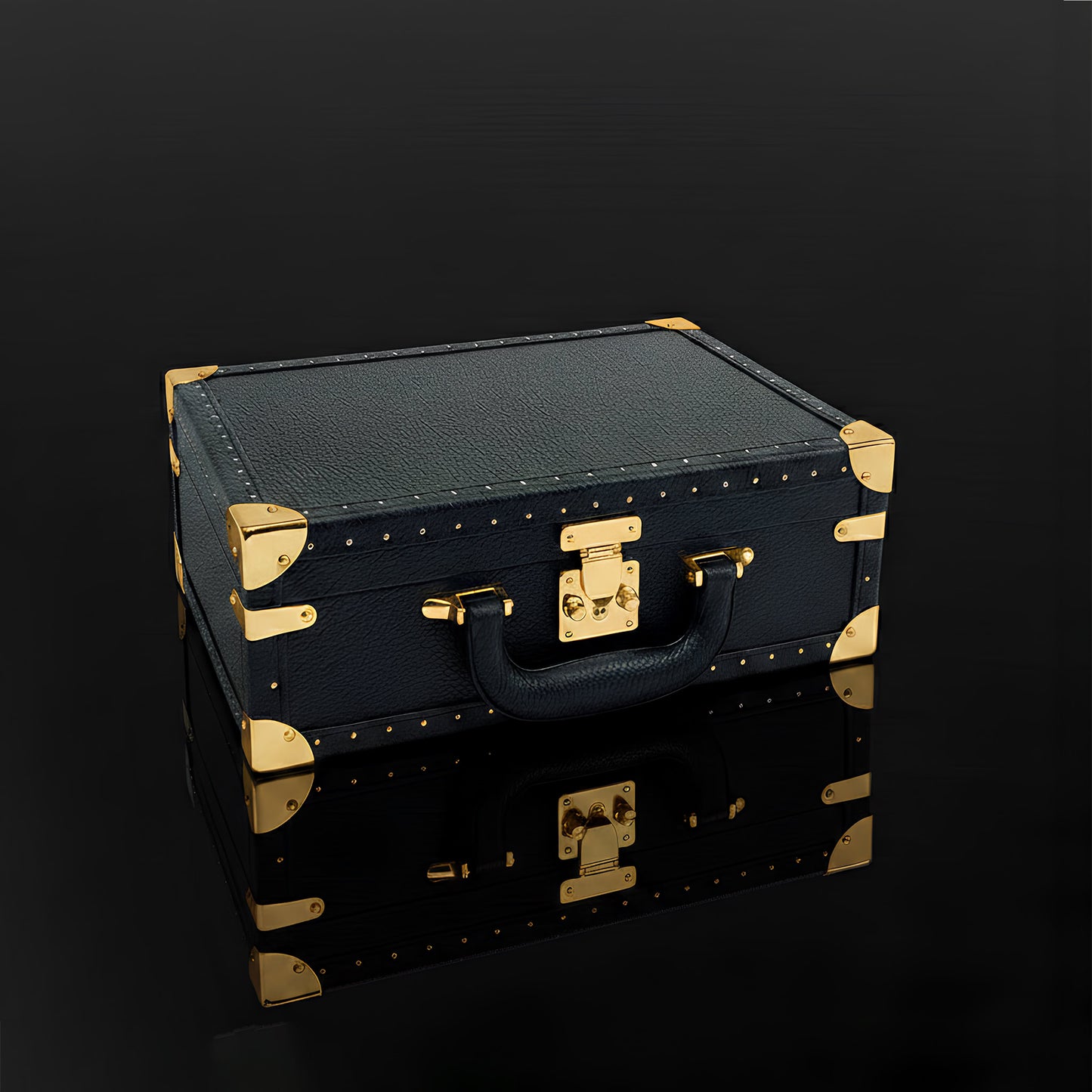 KAMOU Luxury Art Toy Black leather suitcase with gold accents on a dark background
