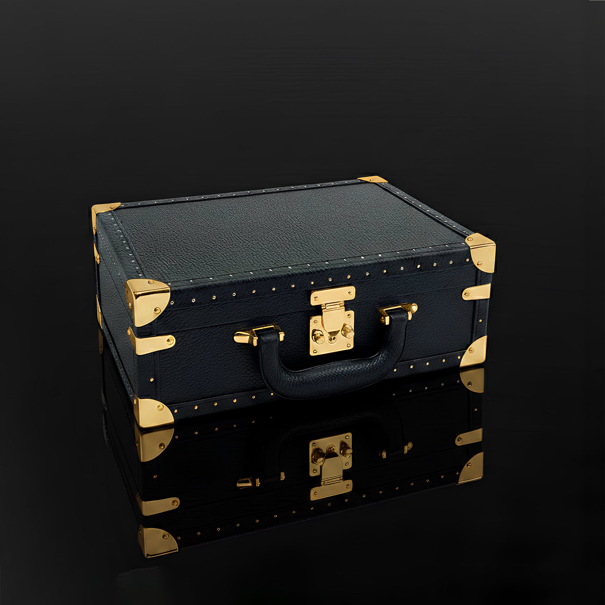 KAMOU Luxury Art Toy Black leather suitcase with gold accents on a dark background